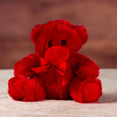 stuffed 6 in red bright and cheery bear with bow around her neck