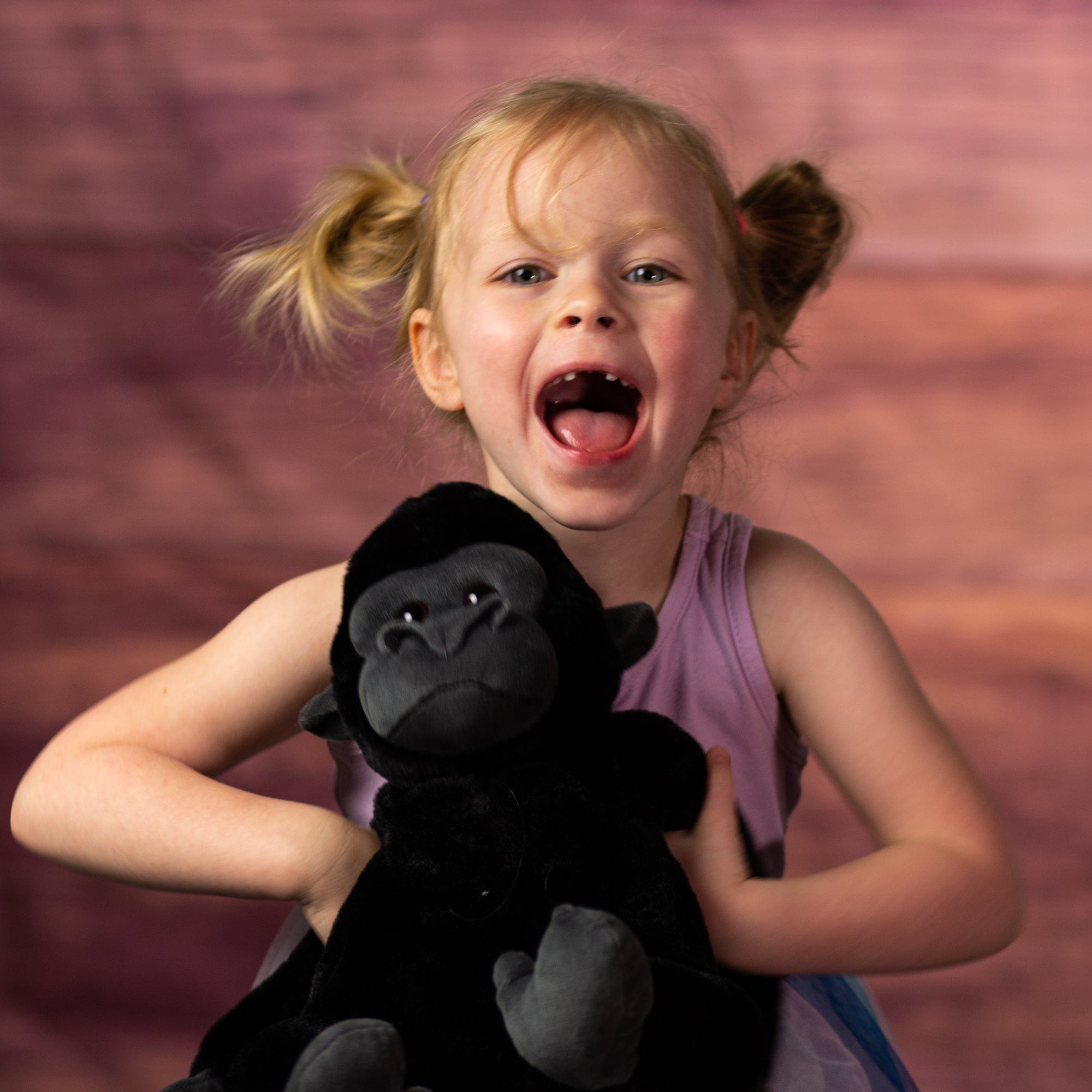 girl holding 12 in stuffed black silverback gorilla