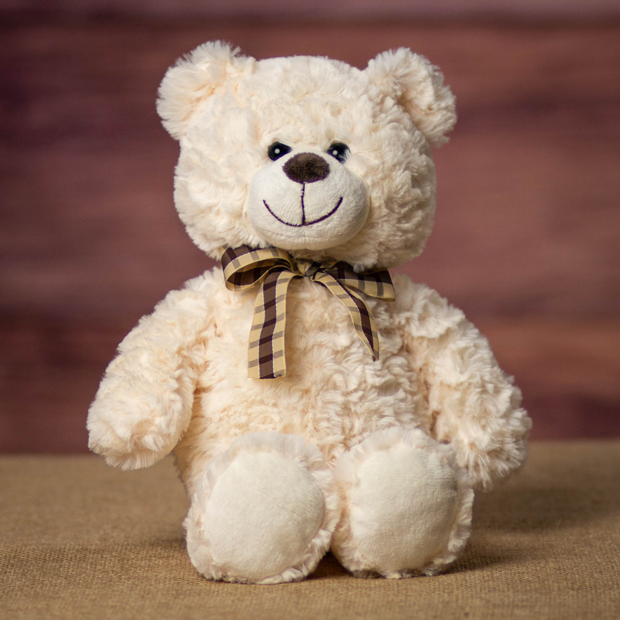 A cream bear that is 13 inches tall while standing