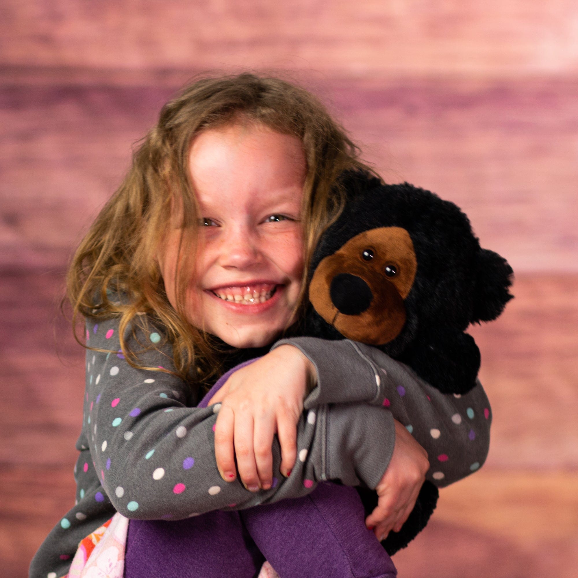 girl holding 10 in stuffed wild black bear