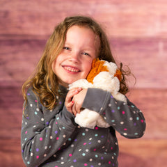 girl holding 7 in stuffed small furry bulldog