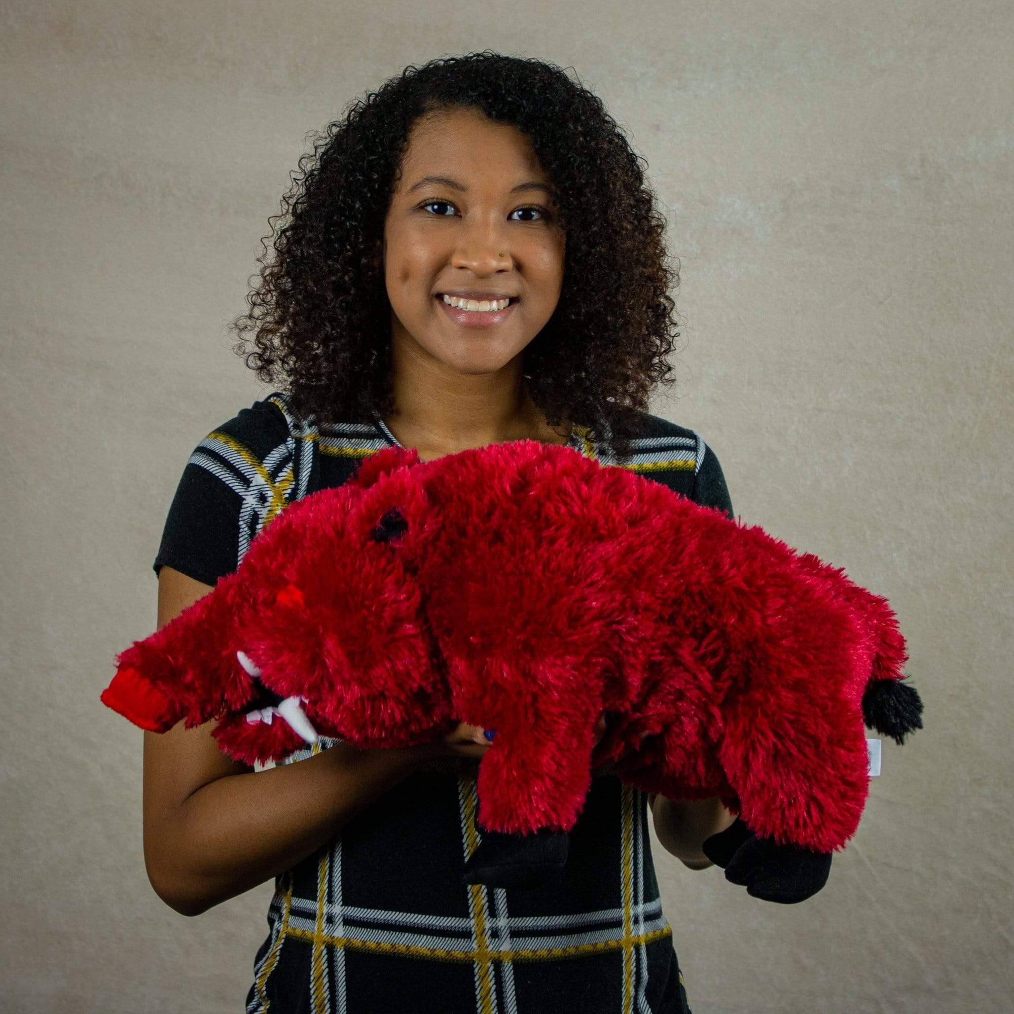 A woman holds a red hog that is 19 inches from head to tail