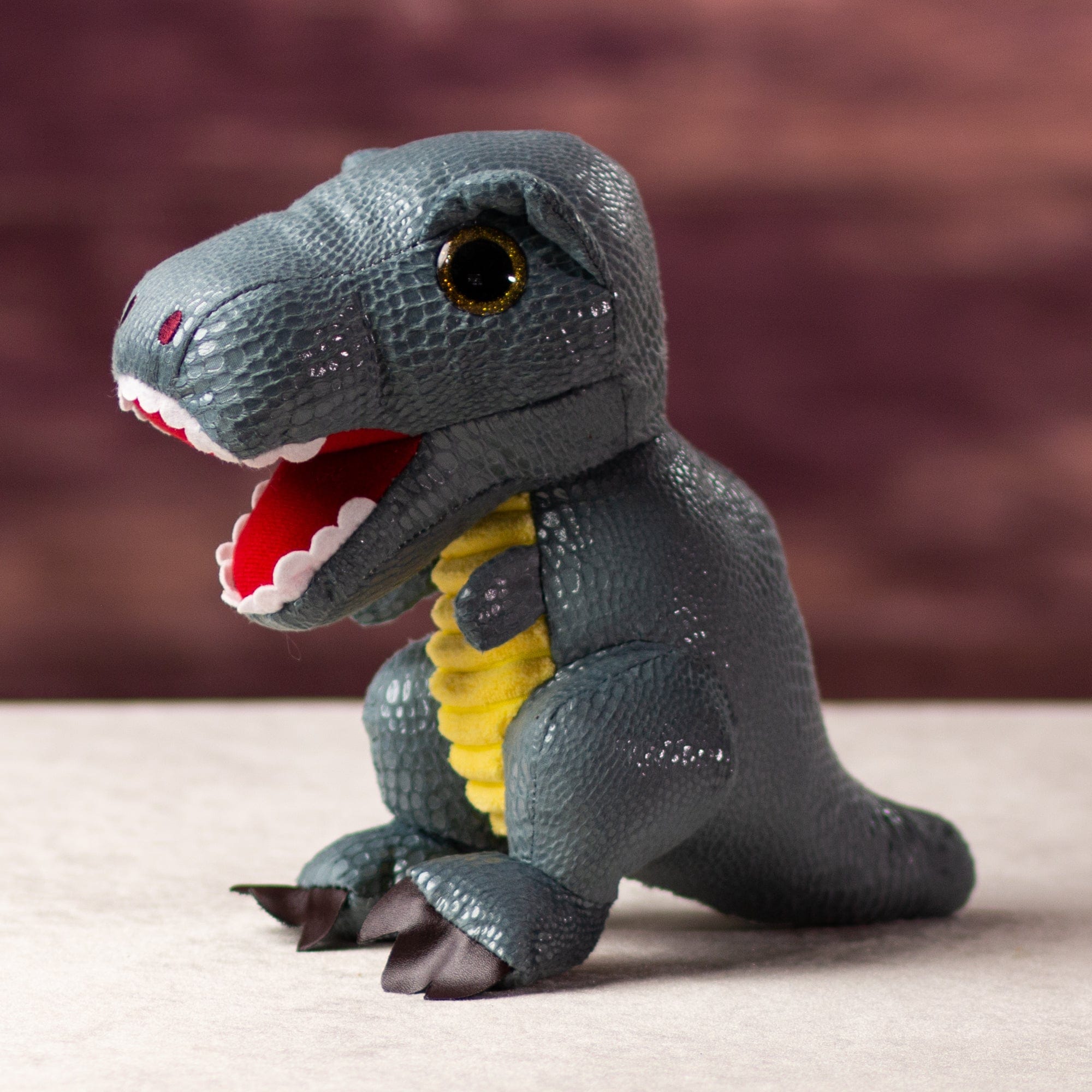 A gray dinosaur that is 9.5 inches tall while standing