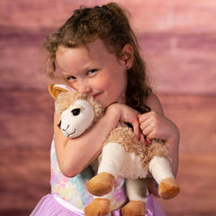 girl holding 10 in stuffed llama with eyelashes