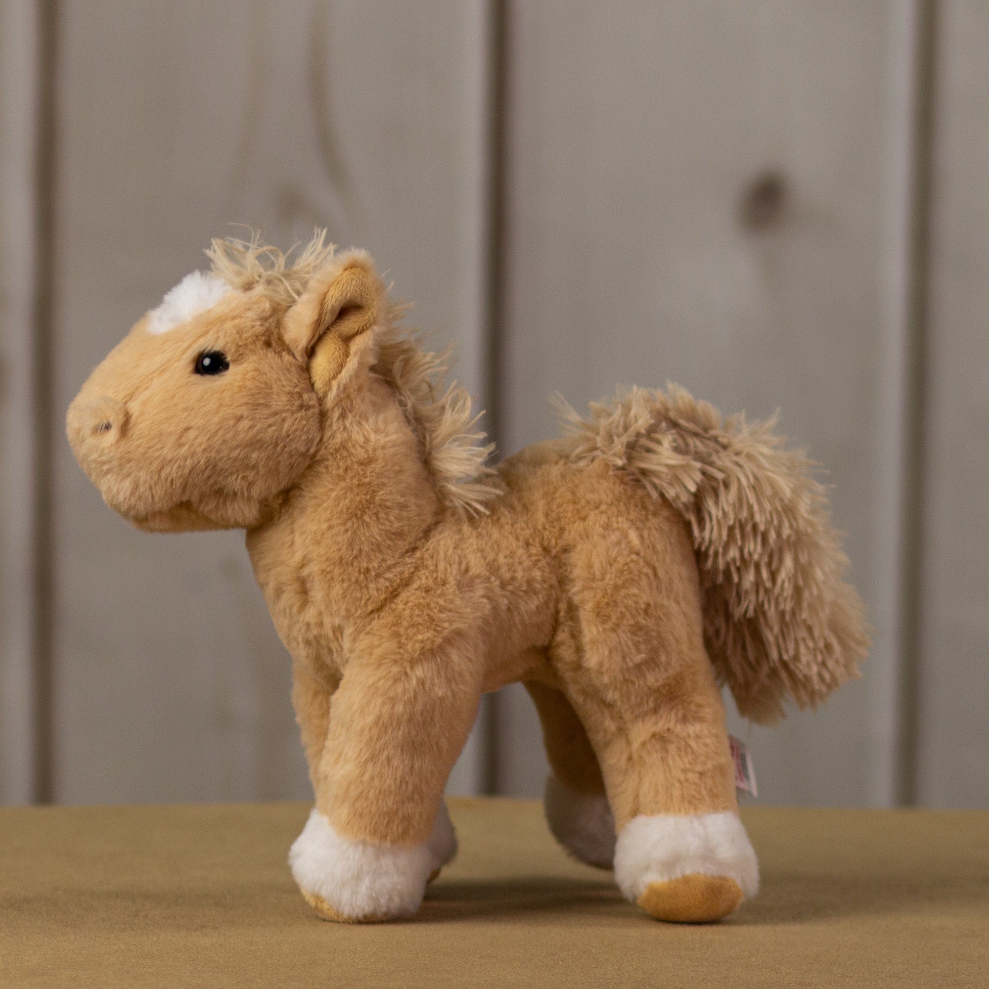 A beige horse that is 10.5 inches tall from head to tail