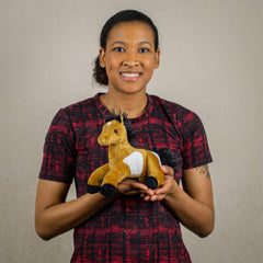 A woman holds a beige horse that is 9 inches from head to tail