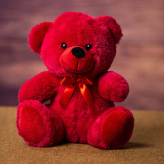 A red bear that is 9 inches tall while sitting