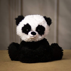 A scruffy black and white panda that is 9.5 inches tall while sitting