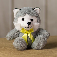 A gray husky that is 7 inches tall while sitting wearing a yellow bow