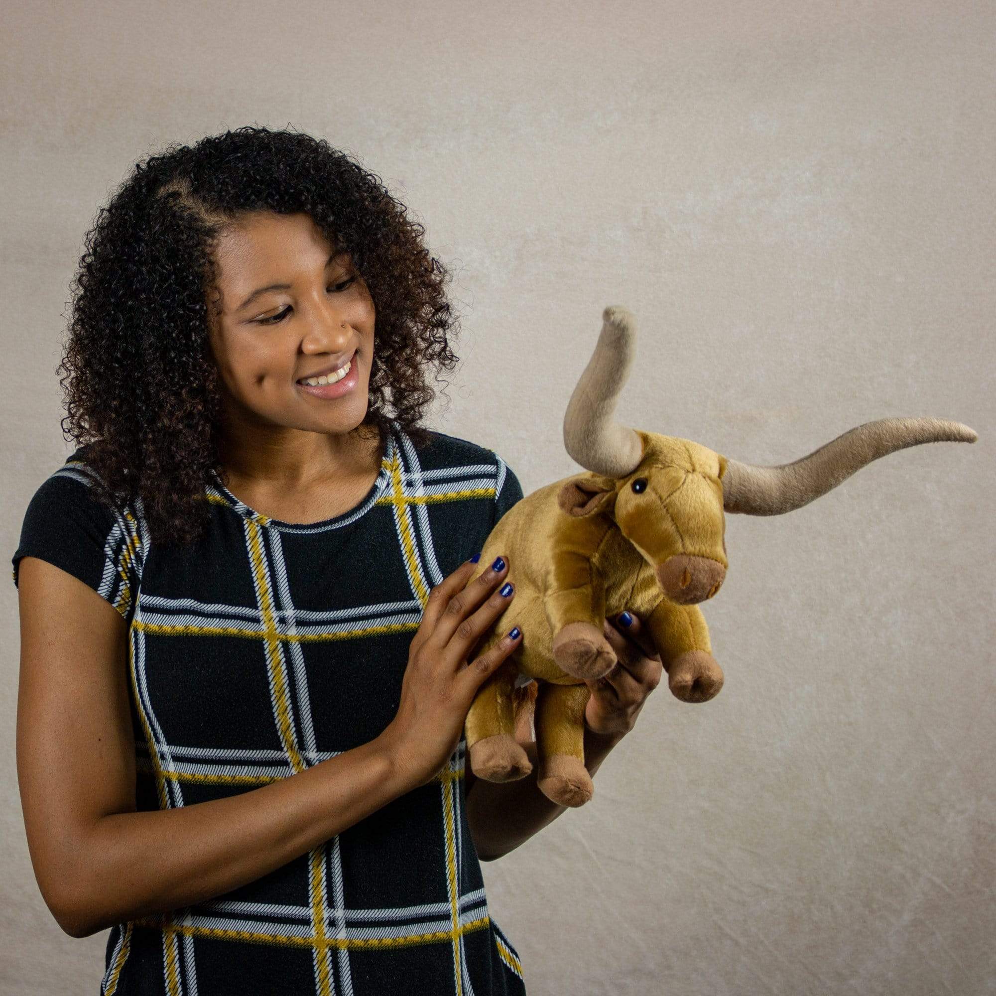 A woman holds a longhorn that is 12 inches from head to tail