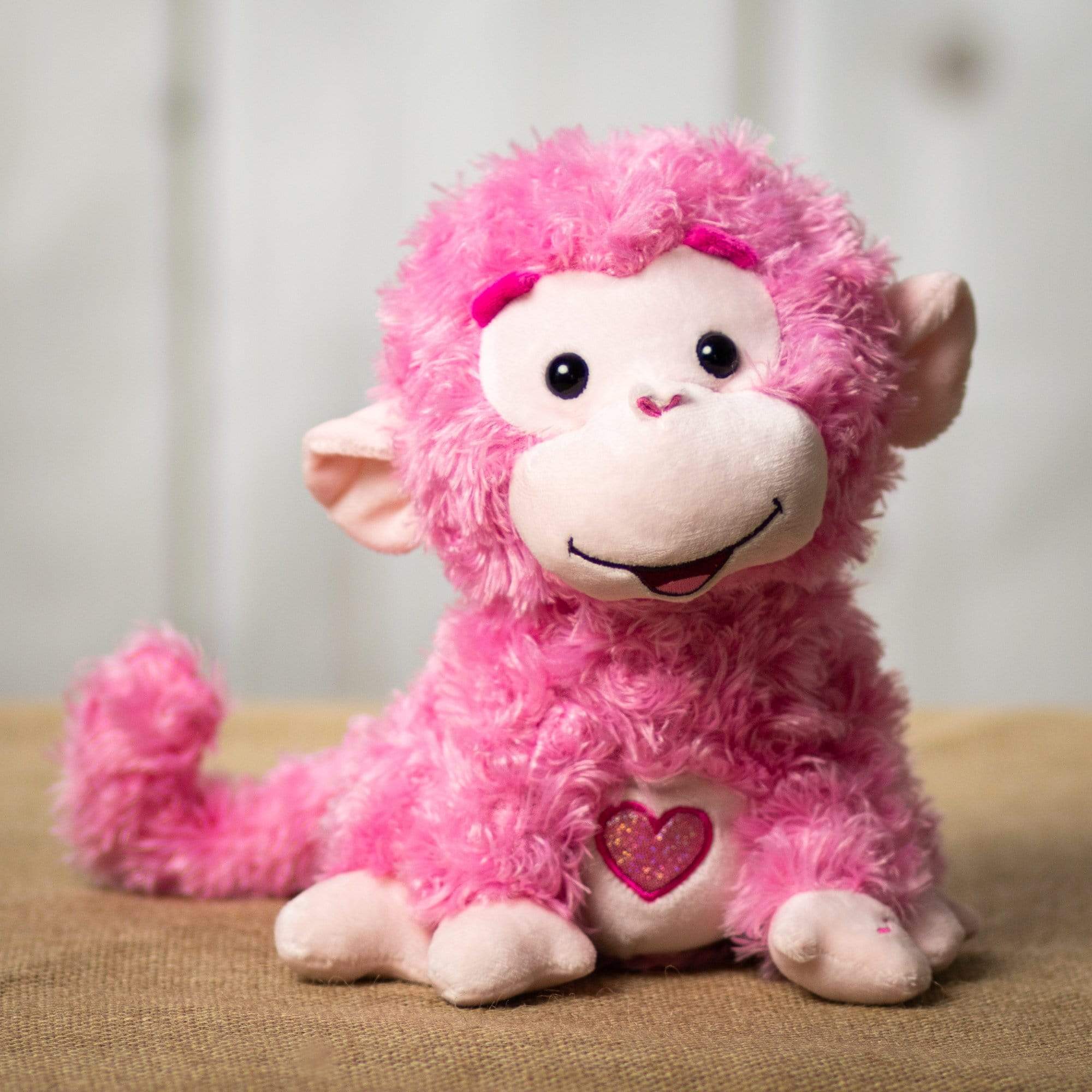 A pink singing/animated monkey that is 10 inches tall while sitting