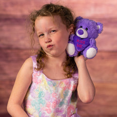 girl holding 5.5 in purple stuffed conversation heart bears